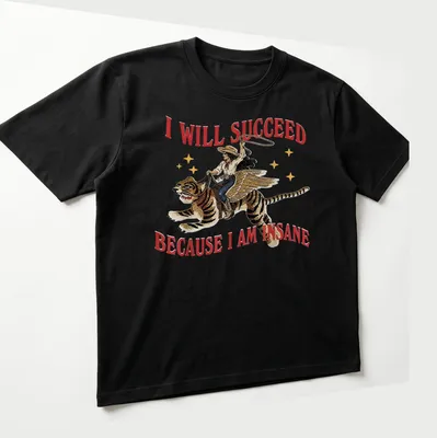 Vintage illustration of a cowgirl riding a tiger with bold text above — printed on a unisex t-shirt (angled view)