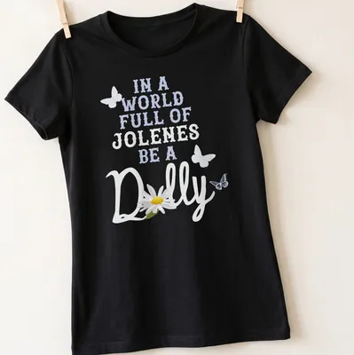 Whimsical daisy illustration with the phrase about Jolene and Dolly on light blue — printed on a women's shirt