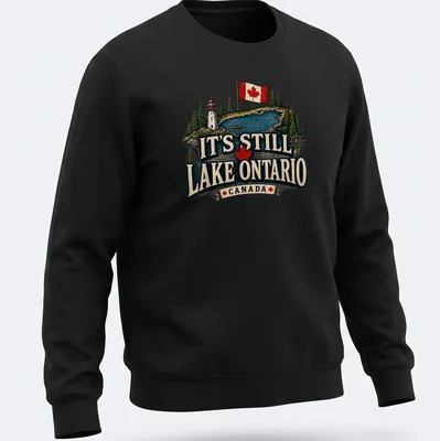Vintage rustic T-shirt featuring Lake Ontario, a lighthouse, and a boat in green, blue, red, cream, and black — printed on a unisex sweatshirt