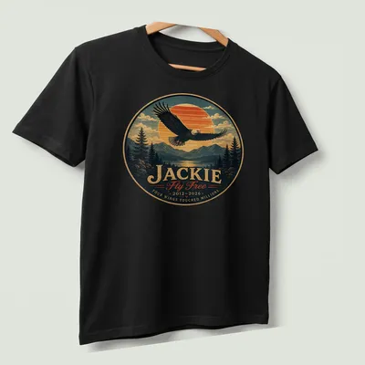 Vintage landscape print featuring a bald eagle with memorial text for Jackie — printed on a unisex t-shirt (angled view)