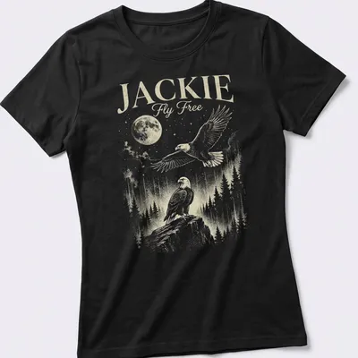 Vintage illustration of an eagle flying with the moon in the background, printed in gold and green. — printed on a women's shirt