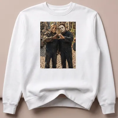Realistic print of Jason Voorhees and Michael Myers forming heart hands — printed on a unisex sweatshirt