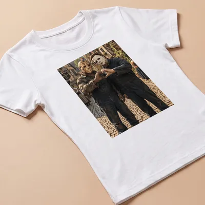Realistic print of Jason Voorhees and Michael Myers forming heart hands — printed on a women's shirt