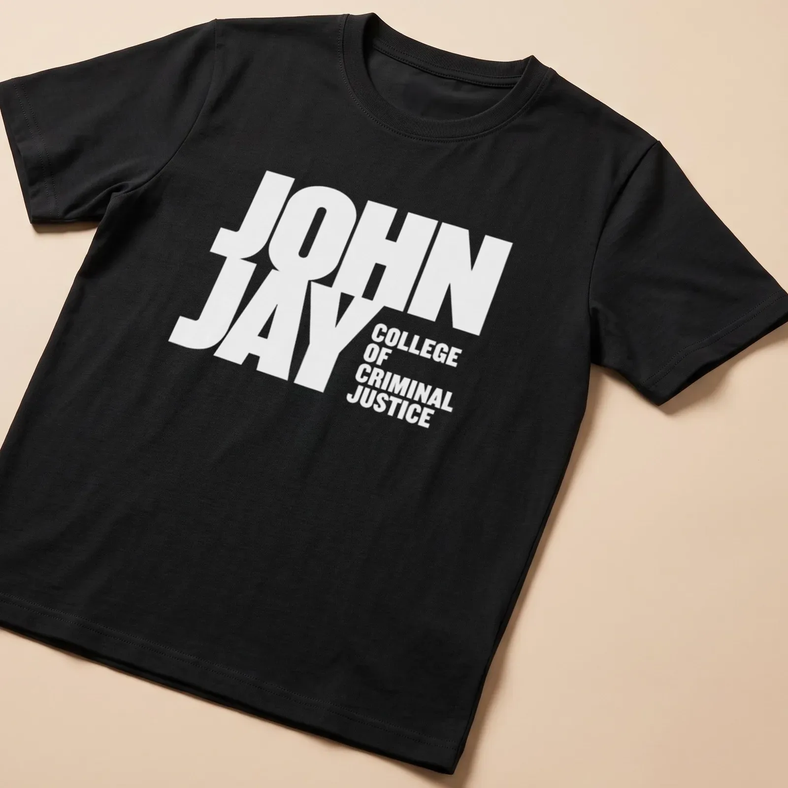 Bold typography t-shirt featuring John Jay College of Criminal Justice — printed on a unisex t-shirt