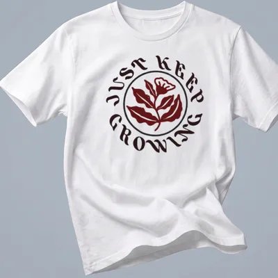 Floral design with leaves and text 'JUST KEEP GROWING' in dark red, green, and white