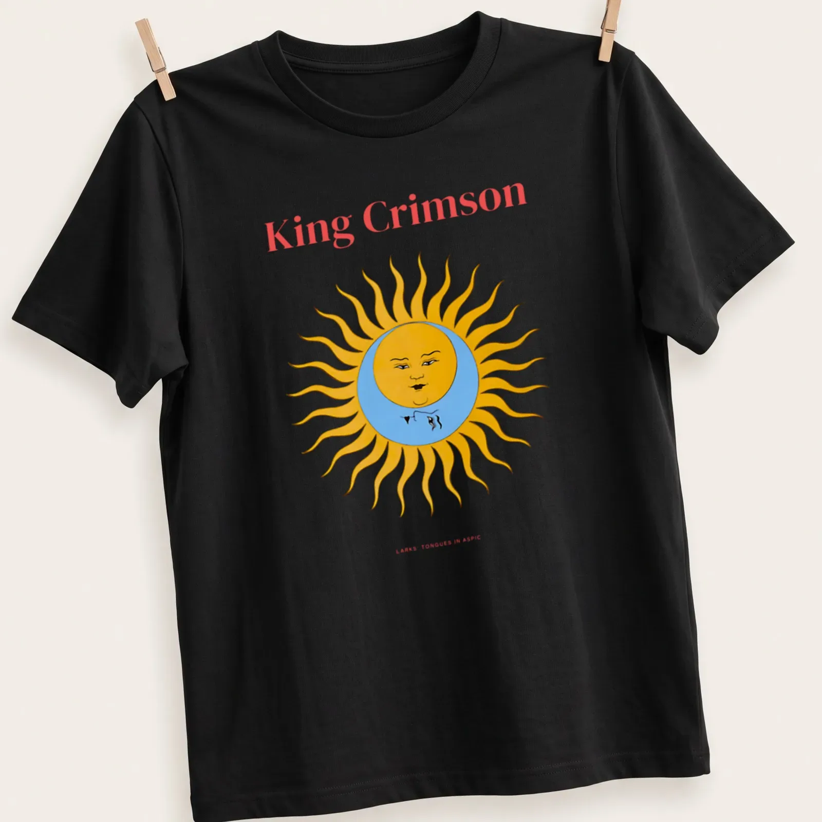 Colorful illustration of a sun with a face and text above it — printed on a unisex t-shirt