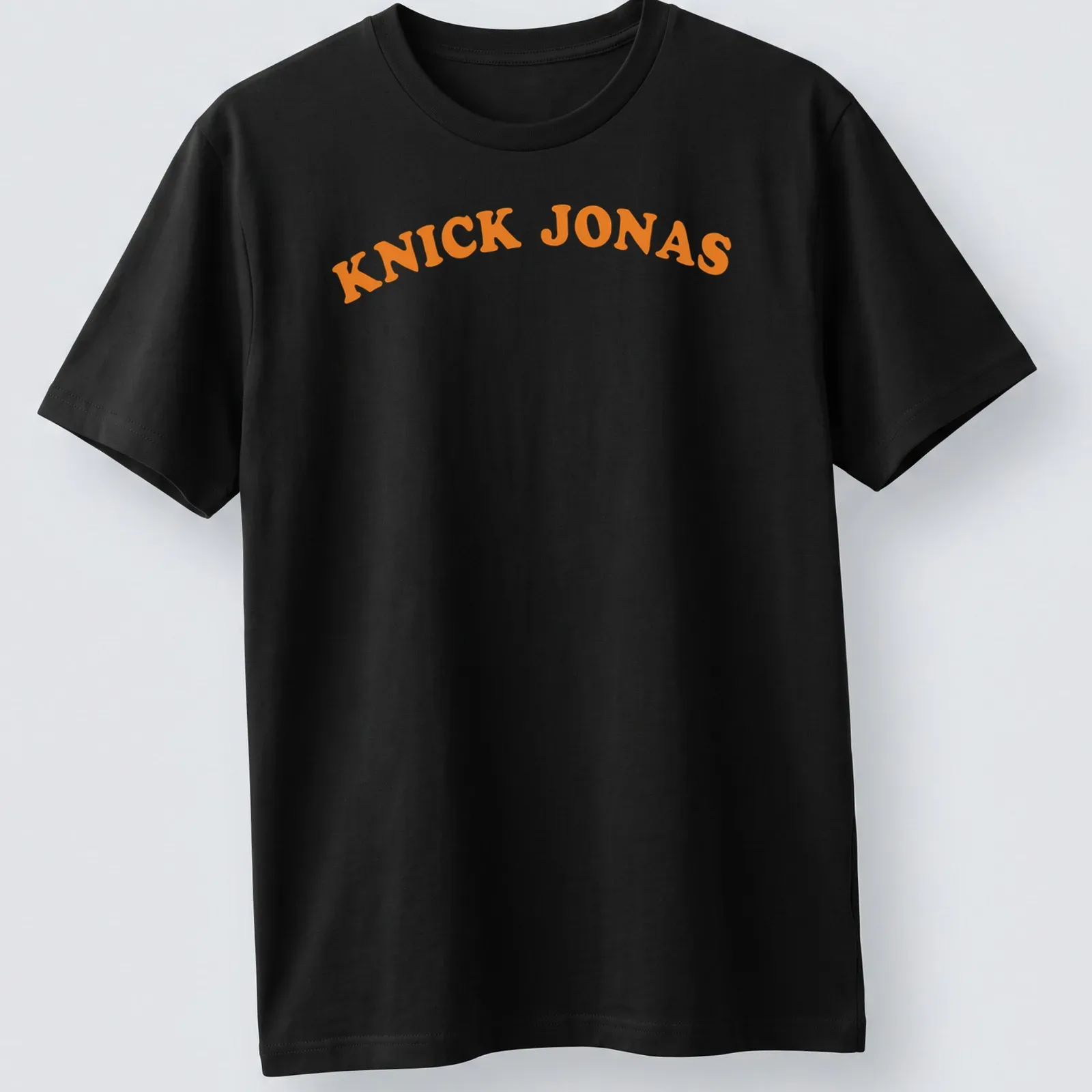 Bold typography of Knick Jonas printed in orange with a basketball pun — printed on a unisex t-shirt