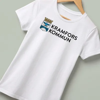 Kramfors Kommun logo t-shirt featuring a coat of arms design in blue, gold, and white — printed on a women's shirt