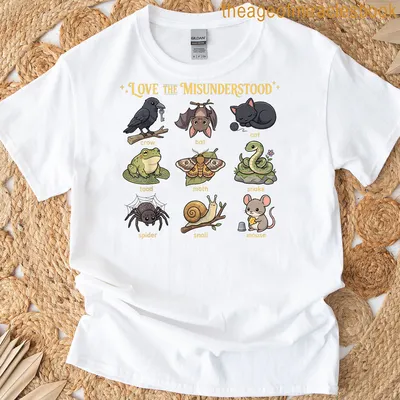 Kawaii cartoon t-shirt featuring a cat, bat, frog, and spider with colorful text.