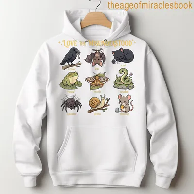 Kawaii cartoon t-shirt featuring a cat, bat, frog, and spider with colorful text. — printed on a unisex hoodie