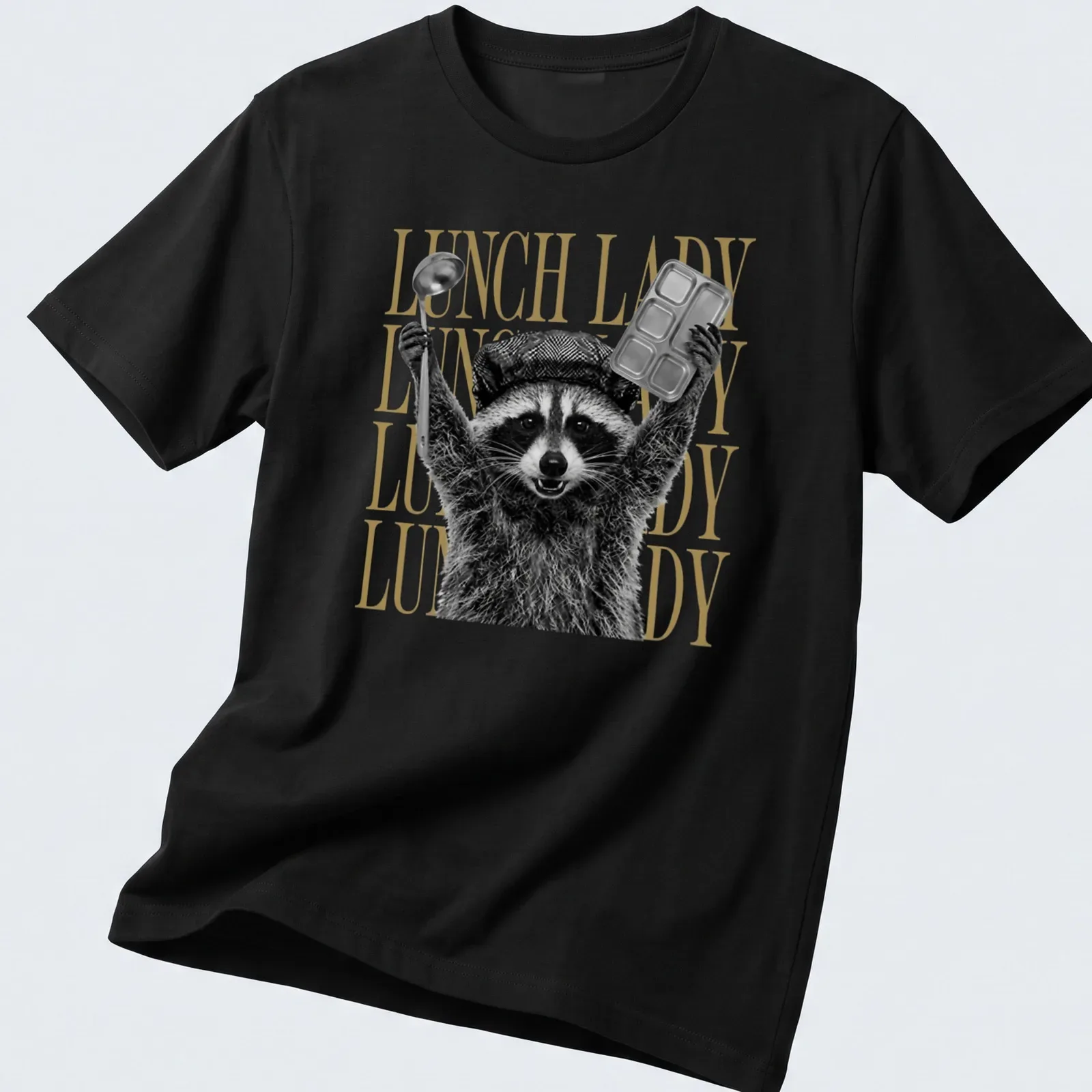 Black and white graphic of a raccoon with bold gold text saying Lunch Lady — printed on a unisex t-shirt