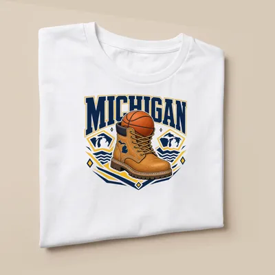 Bold graphic of a work boot and basketball with Michigan text — printed on a unisex t-shirt (angled view)
