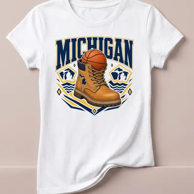 Bold graphic of a work boot and basketball with Michigan text — printed on a women's shirt
