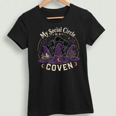 Whimsical illustration of three witch hats with hands and humorous text on a — printed on a women's shirt