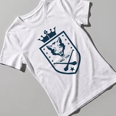 Shield emblem featuring a wolf head and hurling sticks in navy and white — printed on a women's shirt