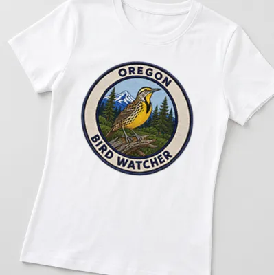 Vintage patch style t-shirt featuring a Western Meadowlark and text about bird watching — printed on a women's shirt