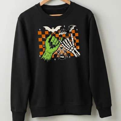Green skeleton hand making a pinky promise, surrounded by cartoon bats — printed on a unisex sweatshirt