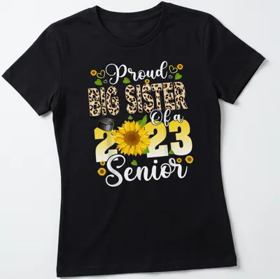 Colorful design featuring a proud big sister message with sunflower and graduation cap — printed on a women's shirt