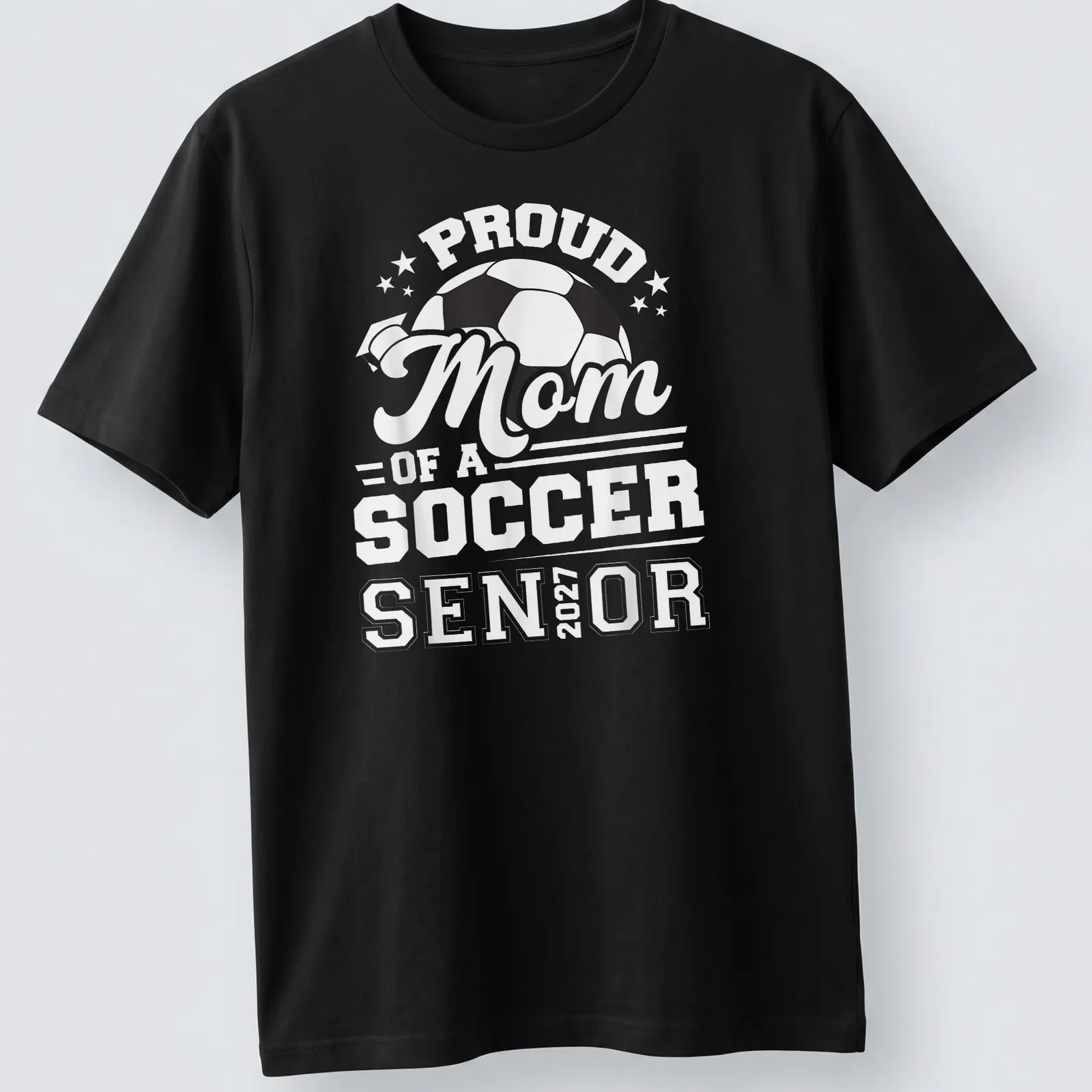 Bold typography celebrating Proud Mom of a Soccer Senior 2027 with a soccer ball — printed on a unisex t-shirt