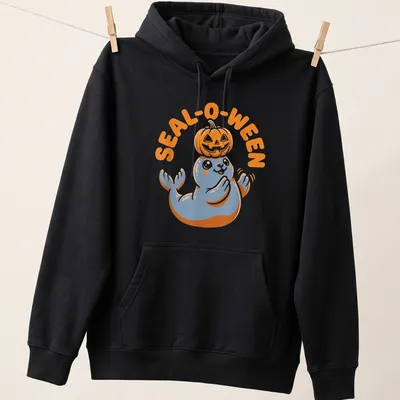 Cartoon seal with pumpkin and text SEAL-O-WEEN in orange, blue, and white — printed on a unisex hoodie