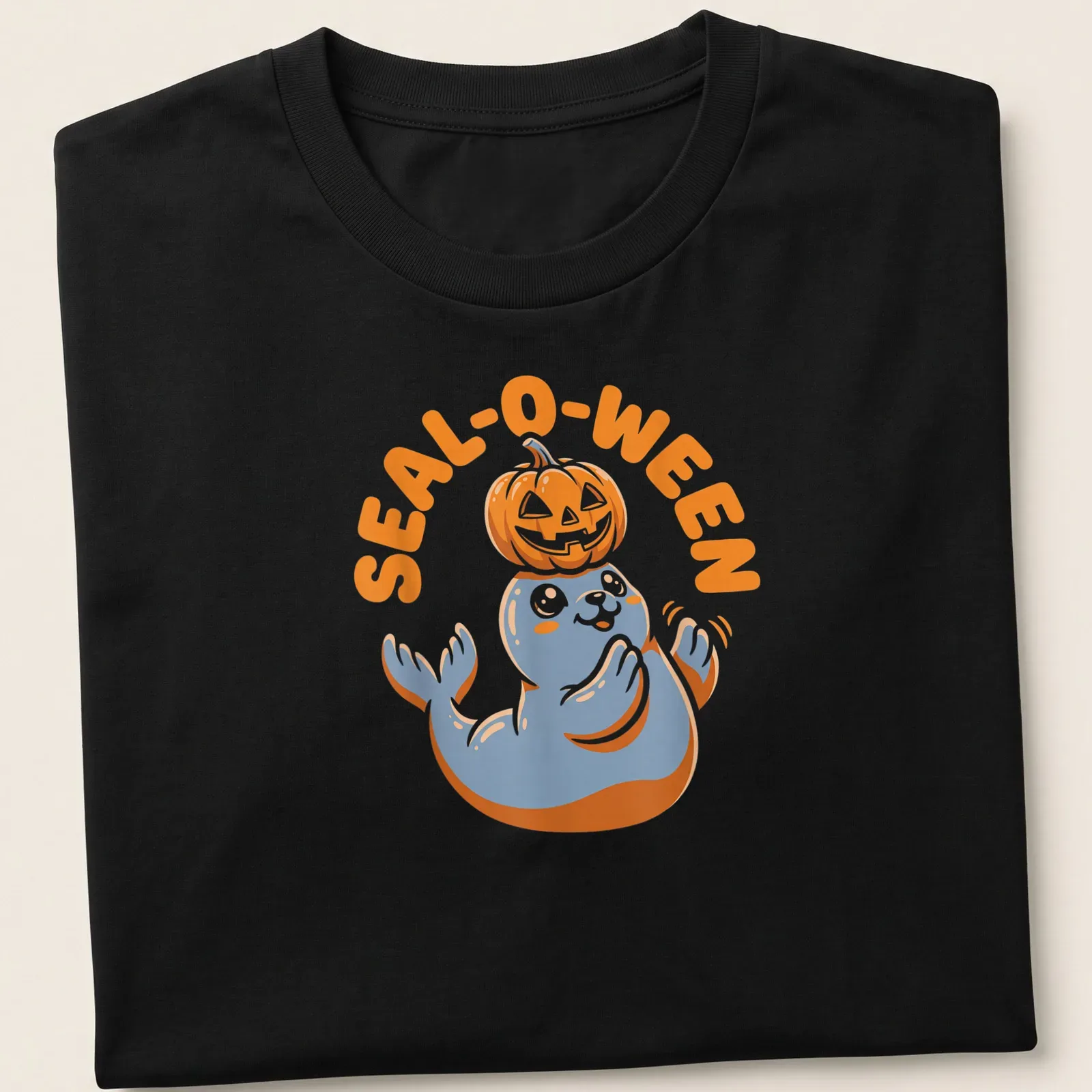 Cartoon seal with pumpkin and text SEAL-O-WEEN in orange, blue, and white — printed on a unisex t-shirt