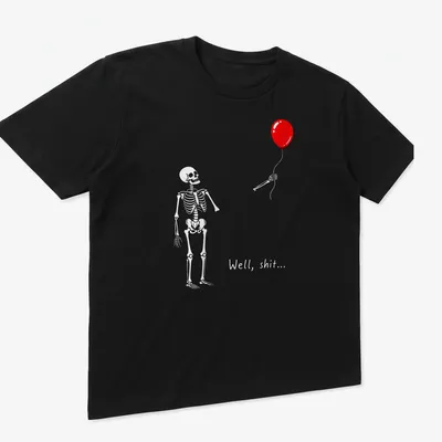 Humorous cartoon skeleton struggling with a red balloon and text saying 'Well, shit...' — printed on a unisex t-shirt (angled view)