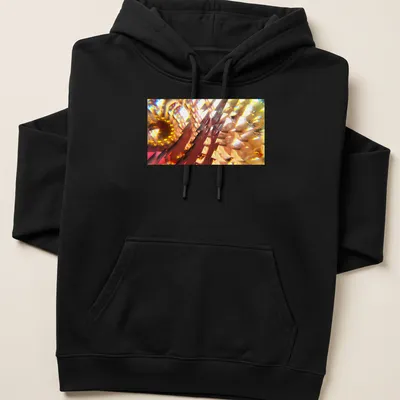 Vibrant digital art of an abstract floral design in yellow, orange, red, gold, and brown. — printed on a unisex hoodie