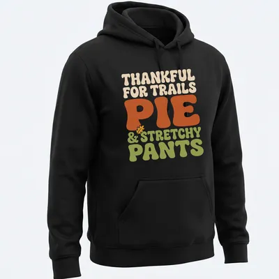 Text-based design celebrating trails, pie, and stretchy pants in retro bold font — printed on a unisex hoodie