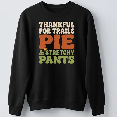 Text-based design celebrating trails, pie, and stretchy pants in retro bold font — printed on a unisex sweatshirt