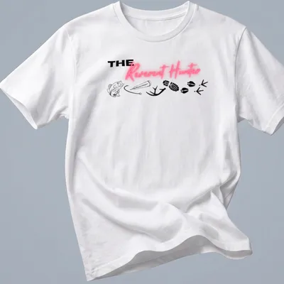 Bold typography tee featuring 'THE Reverent Hunter' with fishing and wildlife elements