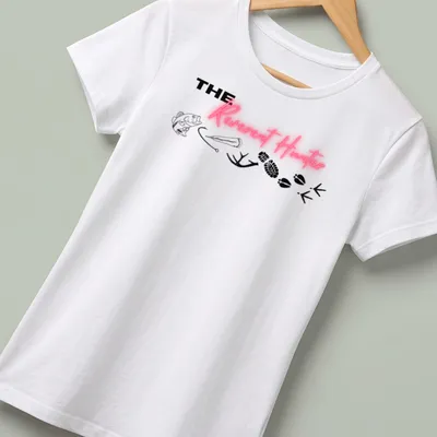 Bold typography tee featuring 'THE Reverent Hunter' with fishing and wildlife elements — printed on a women's shirt
