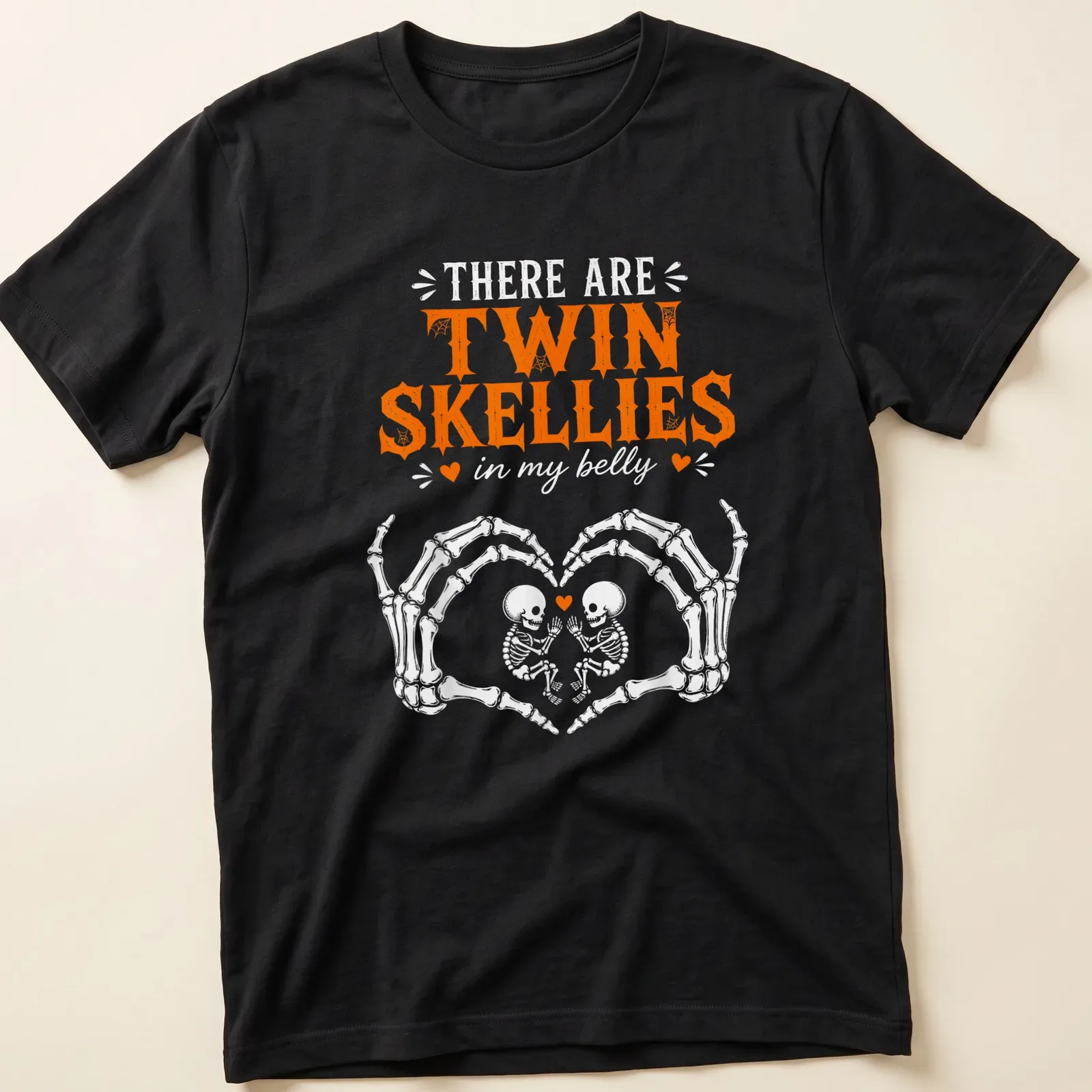 Playful Halloween shirt with twin skeletons and fun text in orange and white — printed on a unisex t-shirt