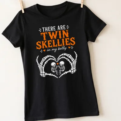 Playful Halloween shirt with twin skeletons and fun text in orange and white — printed on a women's shirt