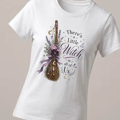 Vintage floral design with a witch broom and the phrase 'There's a Little Witch in all of Us' — printed on a women's shirt
