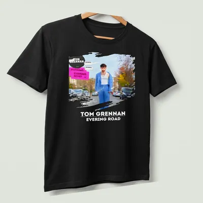 Modern artistic T-shirt featuring Tom Grennan's name with vibrant colors — printed on a unisex t-shirt (angled view)