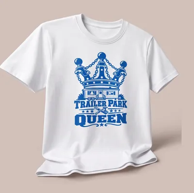 Bold graphic tee featuring a trailer park home with a crown above the text 'TRAILER PARK QUEEN' — printed on a unisex t-shirt (angled view)
