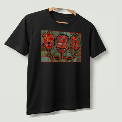 Vibrant geometric print featuring three tribal masks in red, green, yellow, black, and white — printed on a unisex t-shirt (angled view)