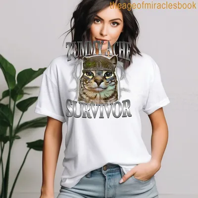 Cartoon cat in helmet with text TUMMY ACHE SURVIVOR underneath — printed on a women's t-shirt