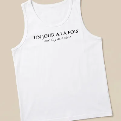 Typographic design with French and English text: Un Jour À La FOIS one day at a time — printed on a tank top
