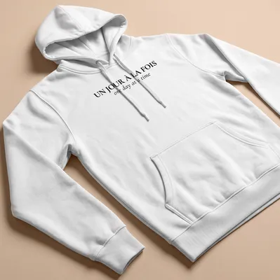 Typographic design with French and English text: Un Jour À La FOIS one day at a time — printed on a unisex hoodie