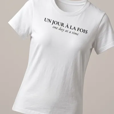 Typographic design with French and English text: Un Jour À La FOIS one day at a time — printed on a women's shirt