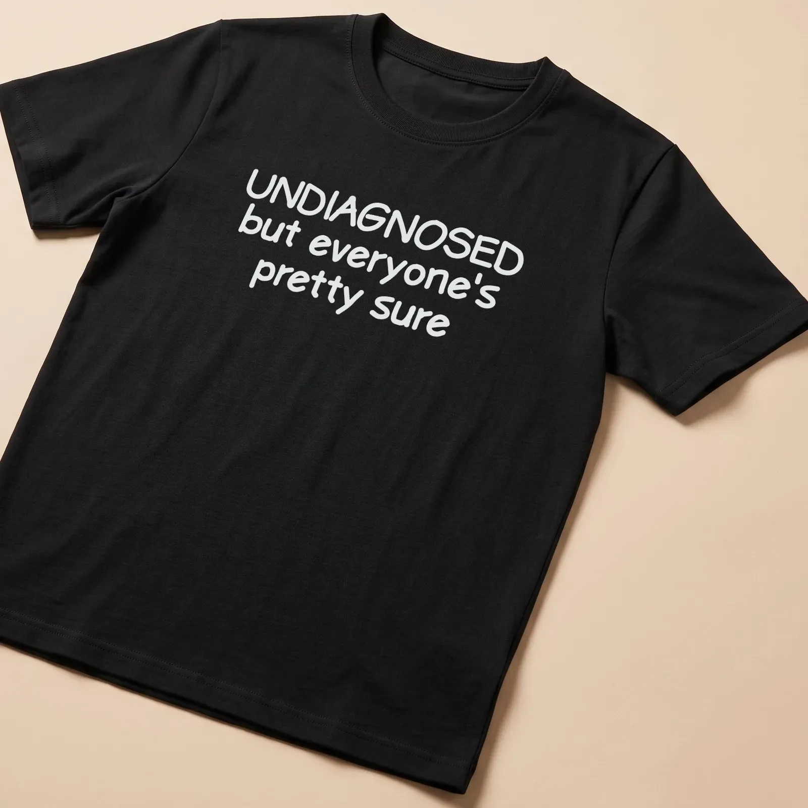 Funny t-shirt with text 'UNDIAGNOSED but everyone's pretty sure' — printed on a unisex t-shirt