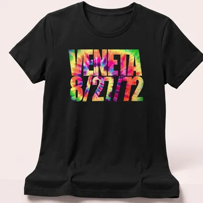 Vibrant tie-dye design with VENETA 8/27/72 text in multiple colors — printed on a women's shirt