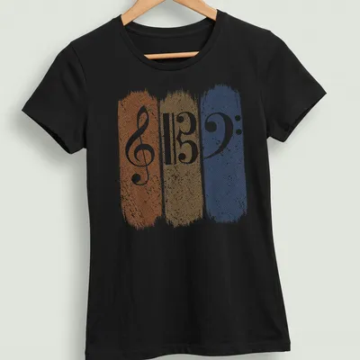 Retro distressed music teacher t-shirt featuring musical clefs in orange, tan, and blue — printed on a women's shirt