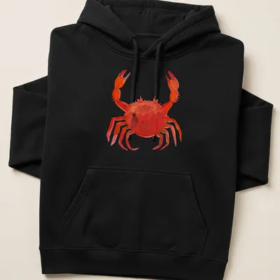 Watercolor print of a lively red crab with orange and black accents — printed on a unisex hoodie