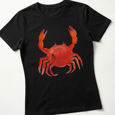 Watercolor print of a lively red crab with orange and black accents — printed on a women's shirt