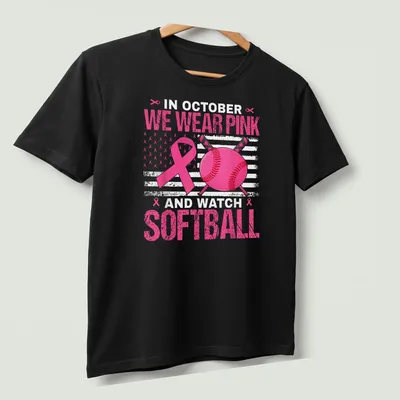 Bold graphic tee featuring pink ribbon and softball design — printed on a unisex t-shirt (angled view)