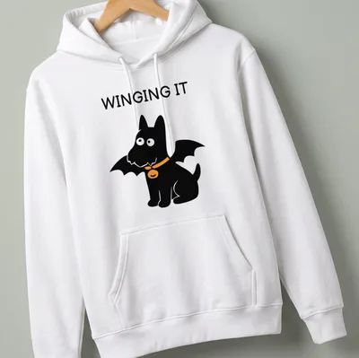 Cartoon Scottish Terrier with bat wings and the text WINGING IT in orange and black — printed on a unisex hoodie