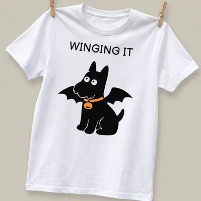 Cartoon Scottish Terrier with bat wings and the text WINGING IT in orange and black