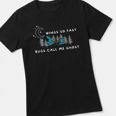Vintage comic style T-shirt featuring a dragonfly with playful text about being elusive — printed on a women's shirt